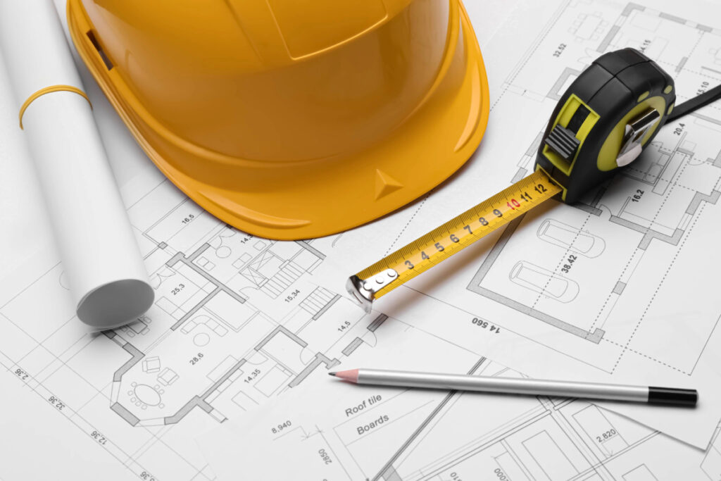 Pencil, measuring tape and hardhat